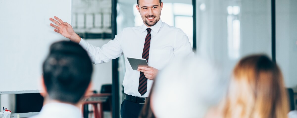 Business professional presenting continuity planning priorities to colleagues during an office meeting