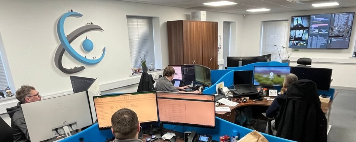 IT support team monitoring systems in a shared office environment, representing Computercentric’s support for distributed teams across the West Midlands