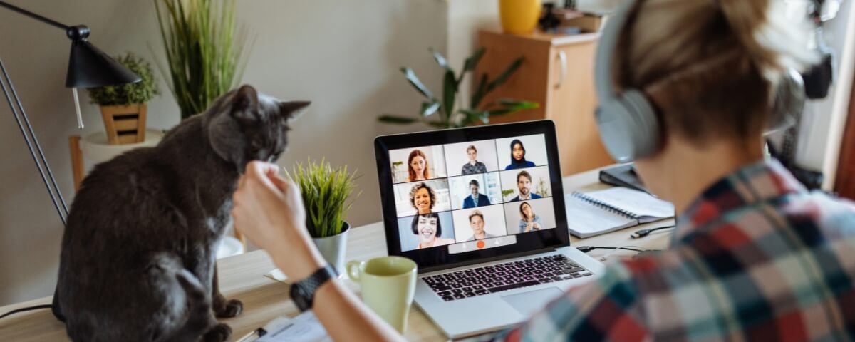 Remote worker using a laptop for a video call from a home office setup, illustrating hybrid working environments outside traditional office IT infrastructure