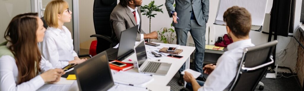 Small business team in an office meeting discussing business continuity planning and disaster recovery priorities