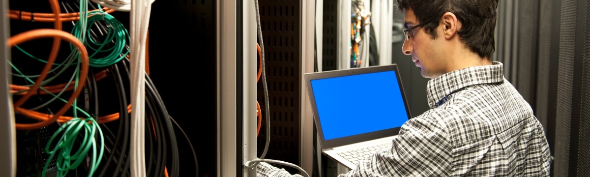 IT support engineer working on business network equipment